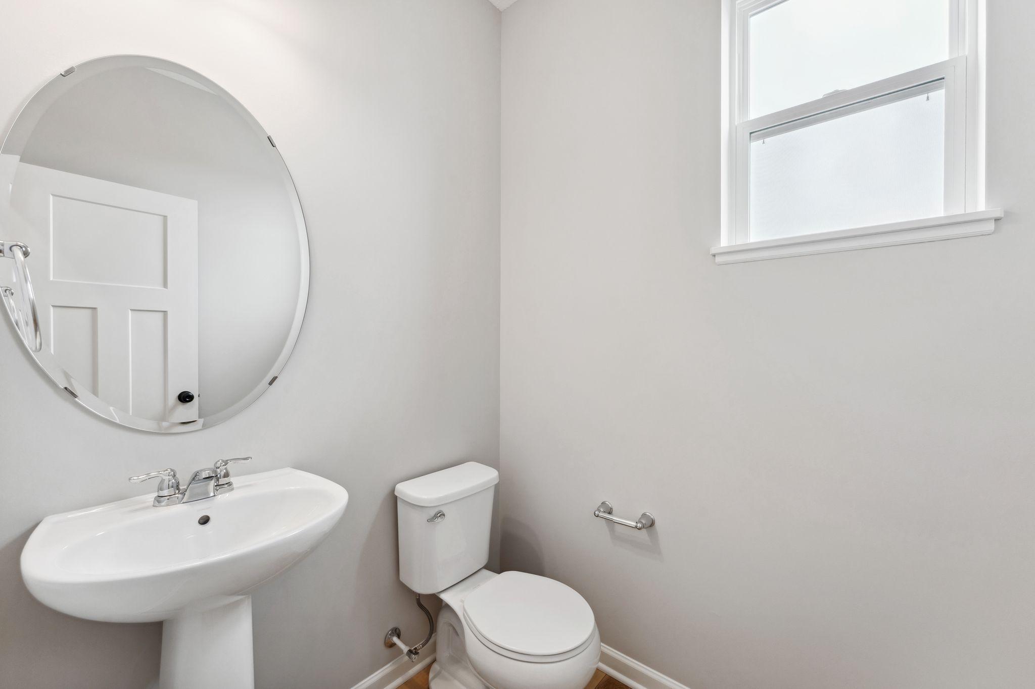 Main level powder room. Similar home shown, color & finish can vary.