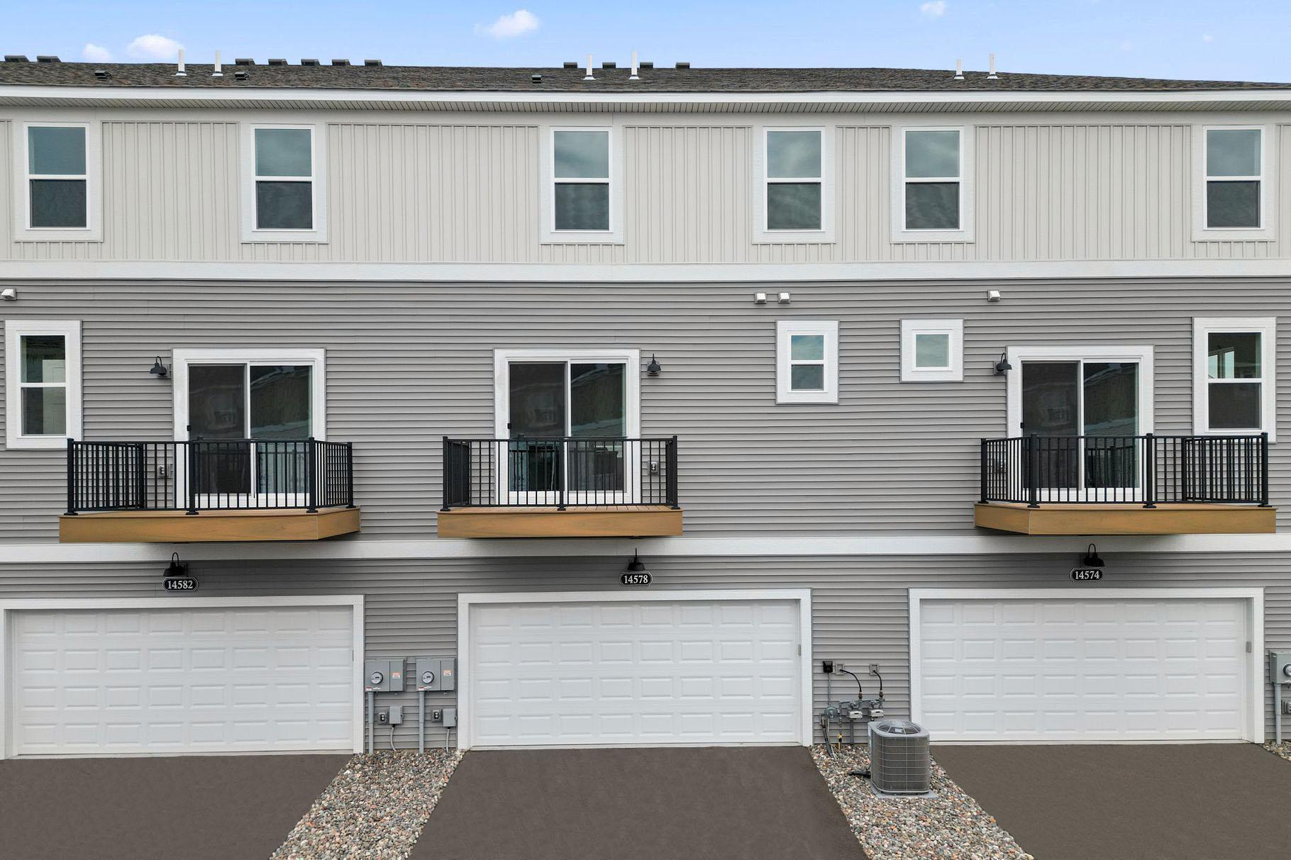 Rear load 2-car garage and maintenance free balcony. Similar home shown, color & finish can vary.