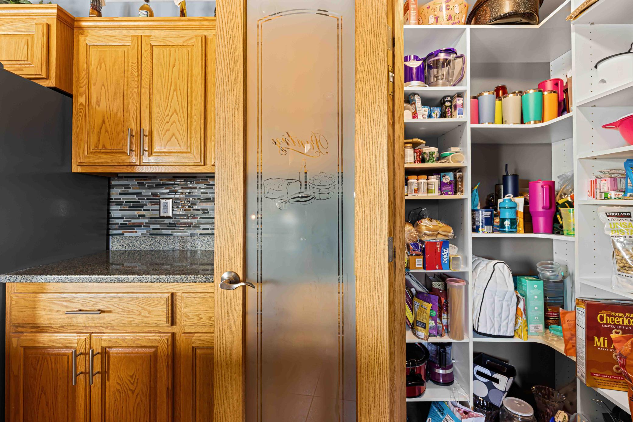 Spacious pantry with a lot of storage throughout kitchen