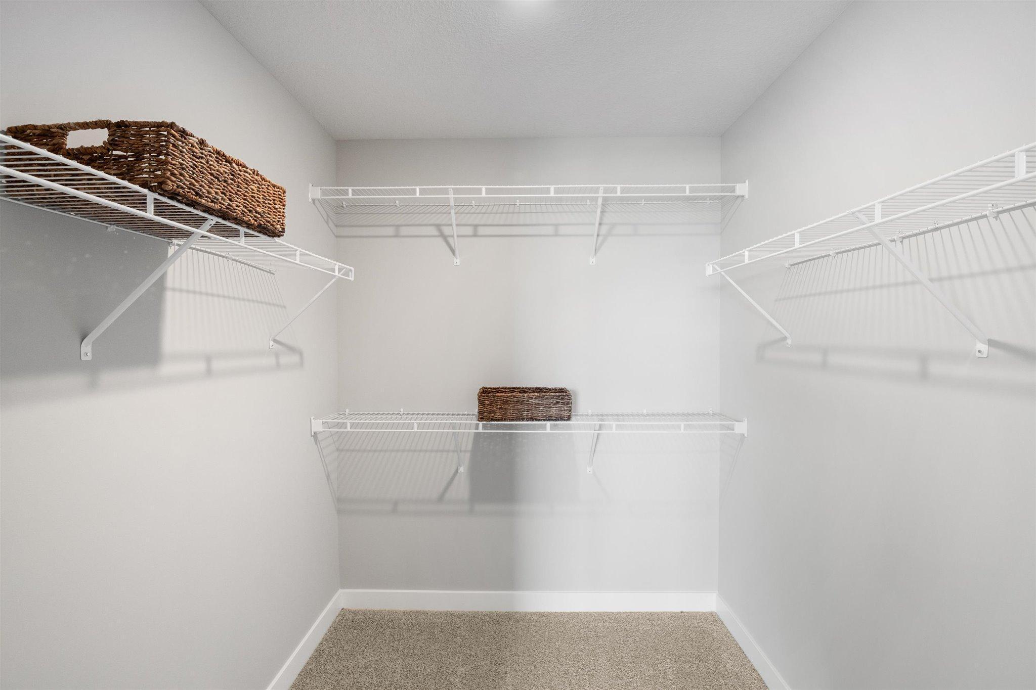 Huge walk-in closet in primary bedroom. Photo of model home. Colors and options may vary. Ask Sales Agent for details.