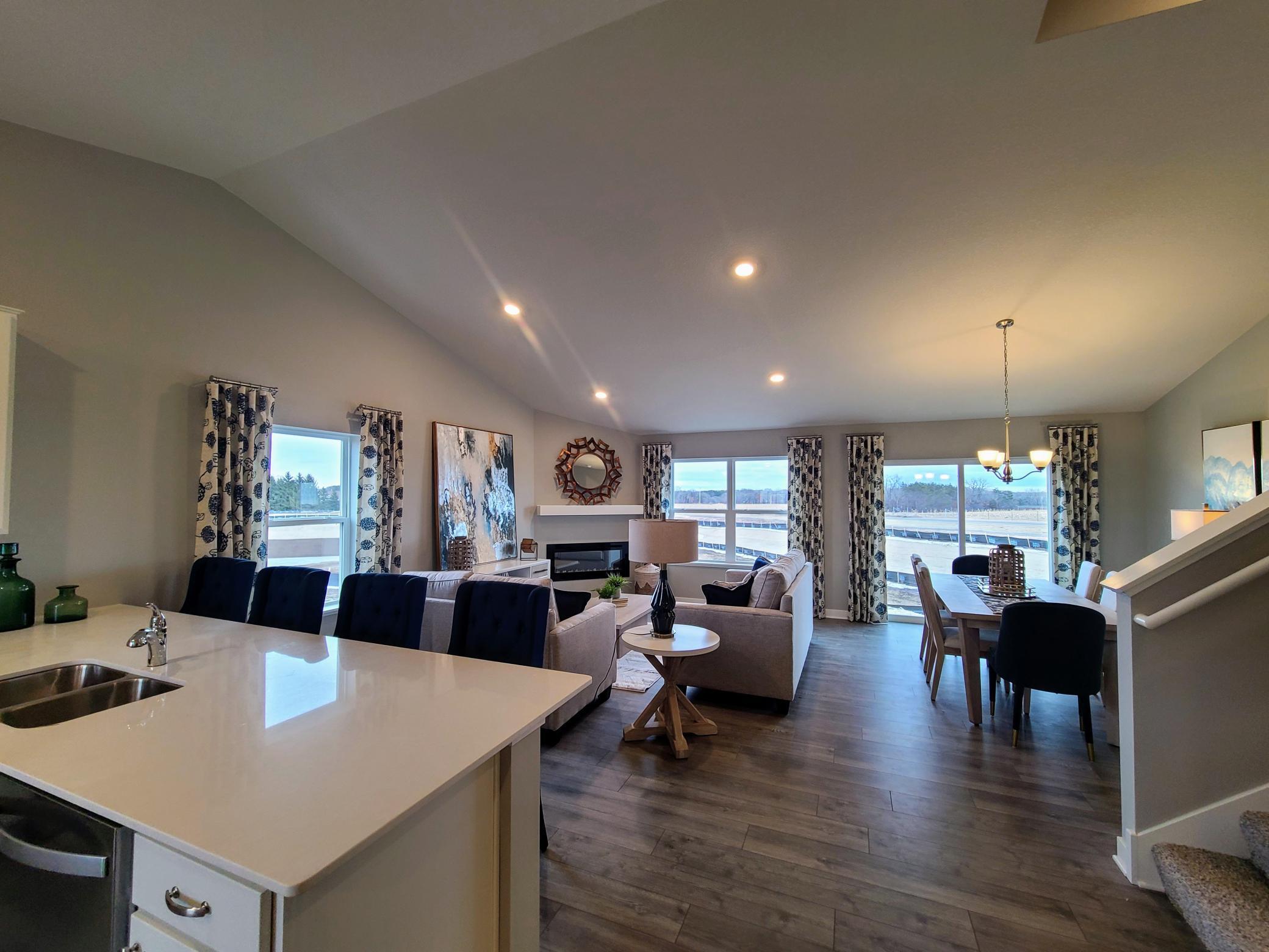Spacious living room and dining room with loads of natural light pouring in. Photo is of model home. Colors and options may vary. Ask Sales Agent for details.
