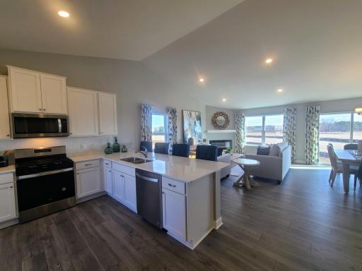Stainless steel appliances and quartz countertops. Photo is of model home. Colors and options may vary. Ask Sales Agent for details.