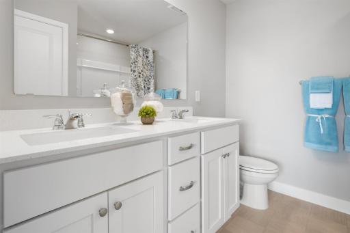 In addition to the space provided in the primary bedroom, the attached bath provides a true oasis to come home to, featuring a double vanity and stand-in shower. Photo is of model home. Colors and options may vary. Ask Sales Agent for details.