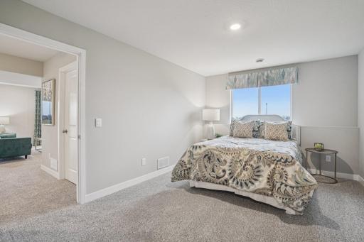 The lower level also includes this large bedroom, which has its own walk-in closet and immediate access to a full bathroom. Photo is of model home. Colors and options may vary. Ask Sales Agent for details.