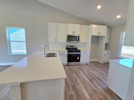 The Bryant II Kitchen shown with White cabinets at Highlands at Eagle View in Elko New Market. Photo is of actual home. Options and colors may vary. Ask Sales Agent for details.