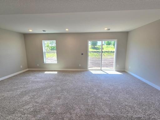The Bryant II Walkout Lower Level Family Room at Highlands at Eagle View in Elko New Market. Photo is of actual home. Options and colors may vary. Ask Sales Agent for details.