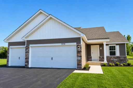 The Bryant II Heartland Cottage shown with optional stone at Highlands at Eagle View! Photo is of actual home. Options and colors may vary. Ask Sales Agent for details. AI-generated landscaping for visualization. Actual yard condition may differ.