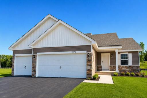 The Bryant II Heartland Cottage shown with optional stone at Highlands at Eagle View! Photo is of actual home. Options and colors may vary. Ask Sales Agent for details. AI-generated landscaping for visualization. Actual yard condition may differ.