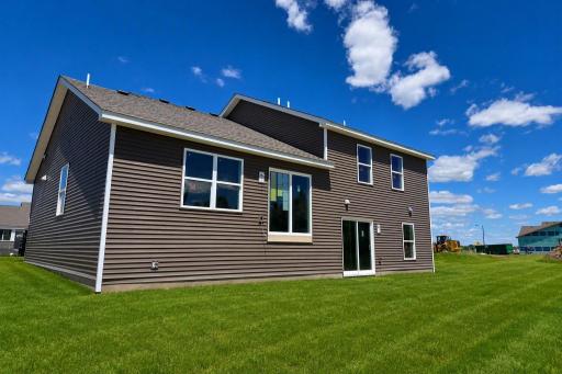 The Bryant II with Walkout Lower Level. Photo is of actual home. Colors and options may vary. Ask Sales Agent for details. AI-generated landscaping for visualization. Actual yard condition may differ.
