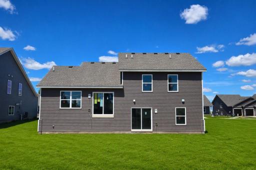 The Bryant II with Walkout Lower Level. Photo is of actual home. Colors and options may vary. Ask Sales Agent for details. AI-generated landscaping for visualization. Actual yard condition may differ.