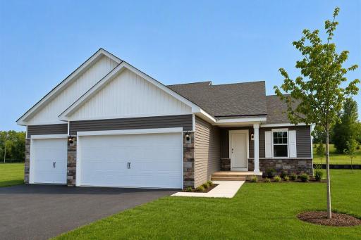 The Bryant II Heartland Cottage shown with optional stone at Highlands at Eagle View! Photo is of actual home. Options and colors may vary. Ask Sales Agent for details. AI-generated landscaping for visualization. Actual yard condition may differ.