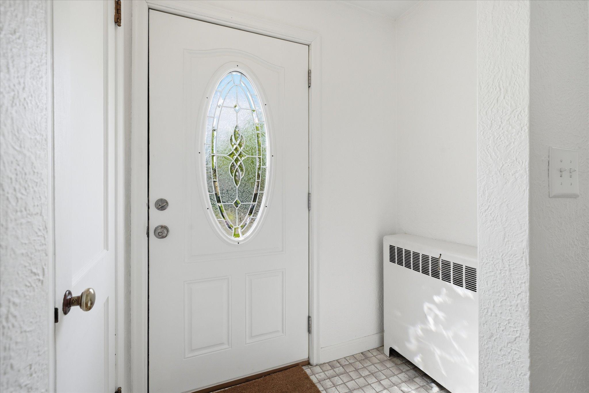 Upon entry through the front door, you will be greeted with a coat closet, tile flooring, bright & modern paint and an upgraded steelcore door.
