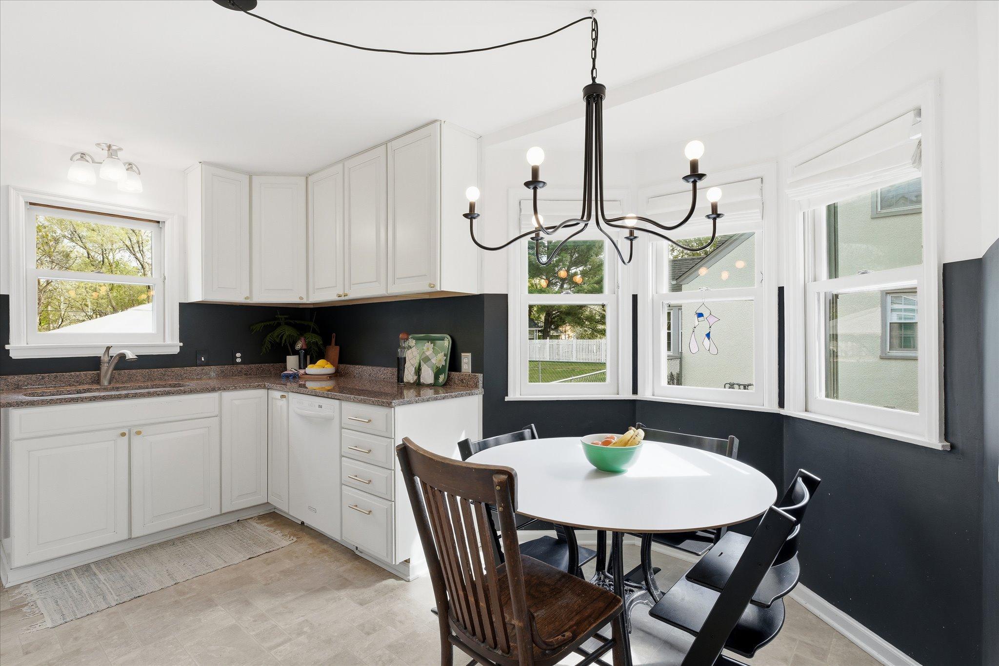 The eat-in kitchen is beautiful - Marvin double pane windows, another modern light fixture, upgraded cabinets & granite countertops.