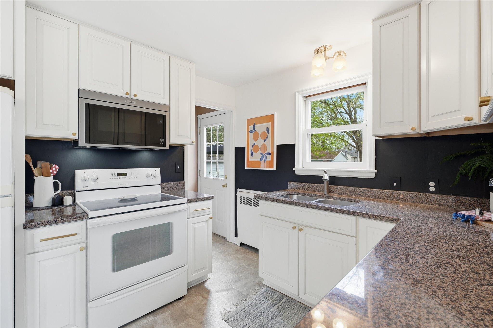 The kitchen leads out the back door - to that big & beautiful back yard. BBQ!?!?
