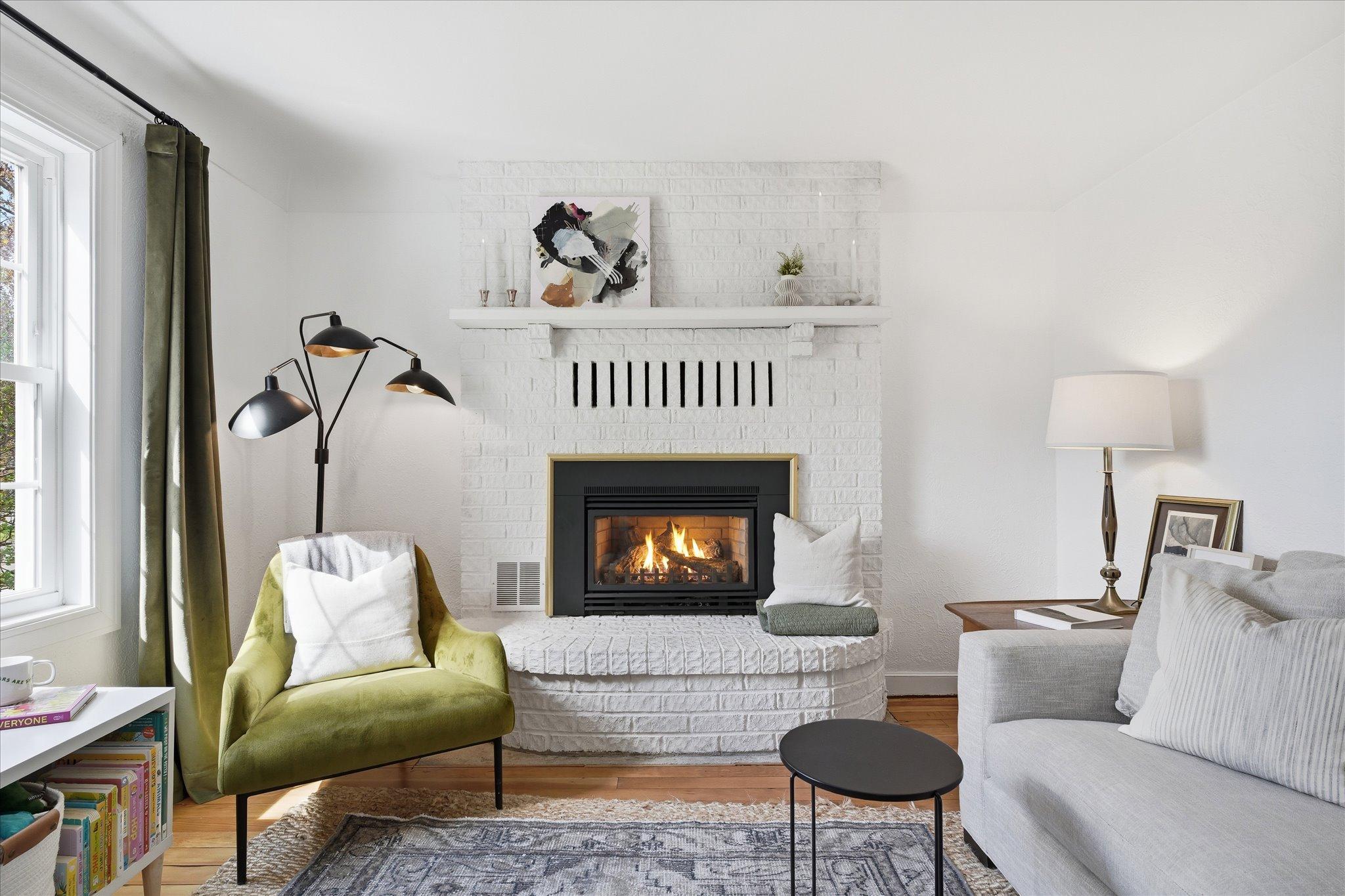The brick surround was painted white to match & blend with the owner's beautiful, modern design style.
