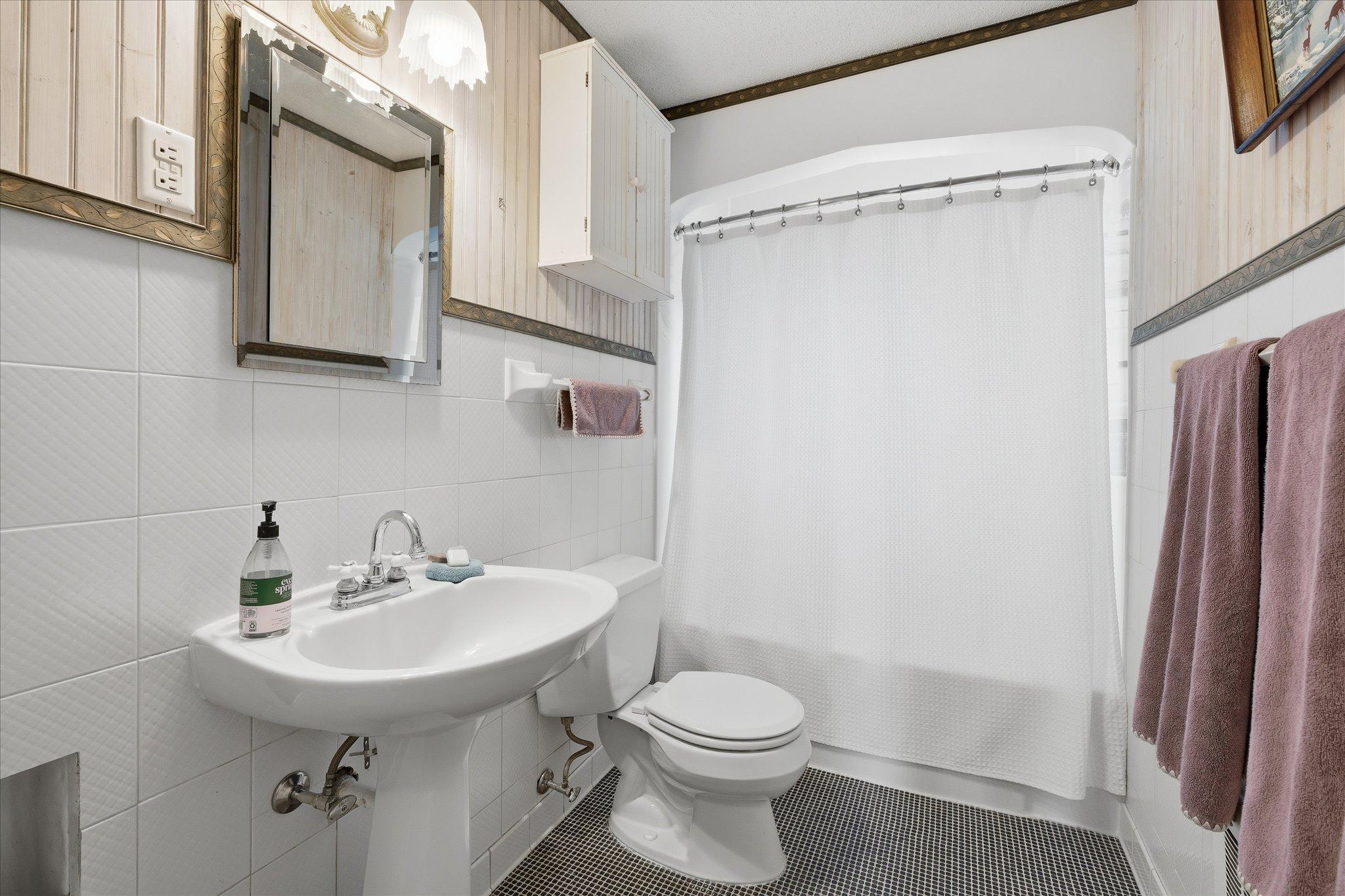 The main level full bath is period-honoring, but modern. Sleek and pretty.