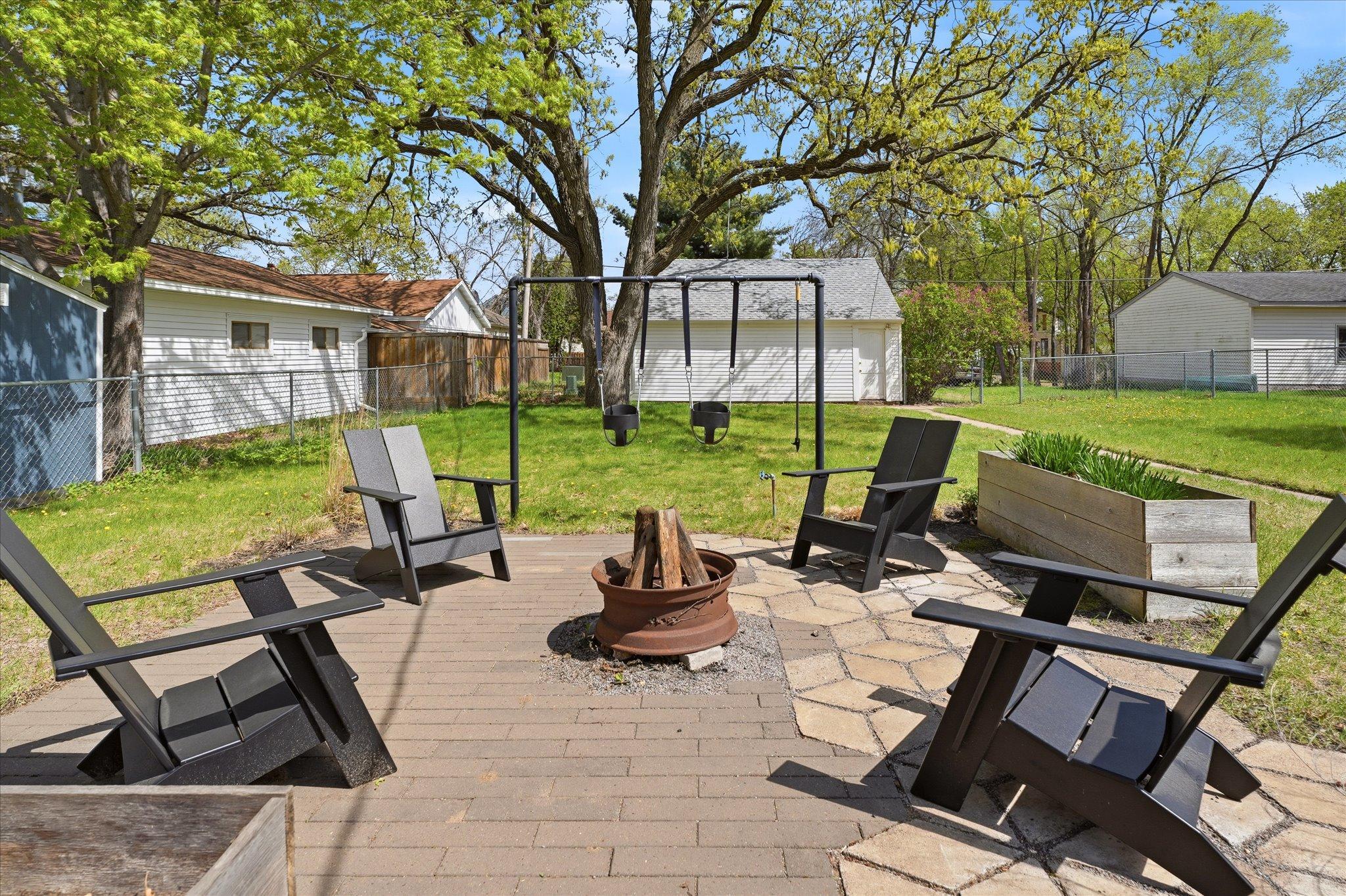 The paver patio comes with the fire ring and the garden beds. Sorry - the chairs are going with the owners.