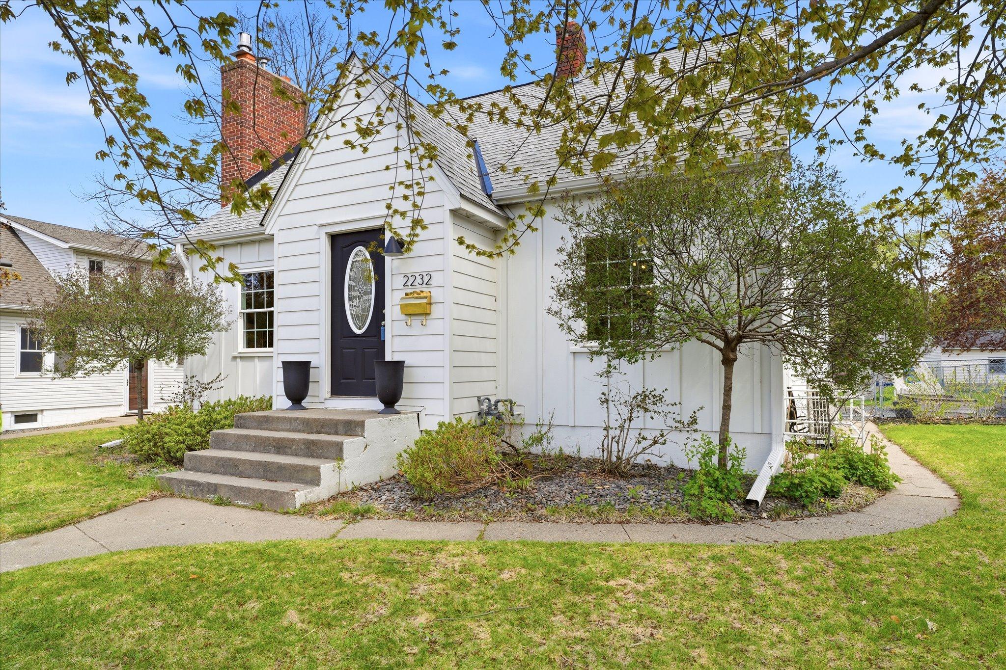 The gold mailbox, the modern address numbers - 2232 - and the black front door make a bold, modern statement.