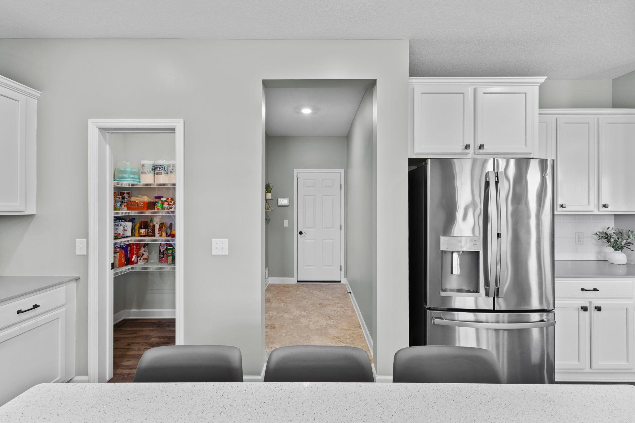 Kitchen offers a generous pantry.