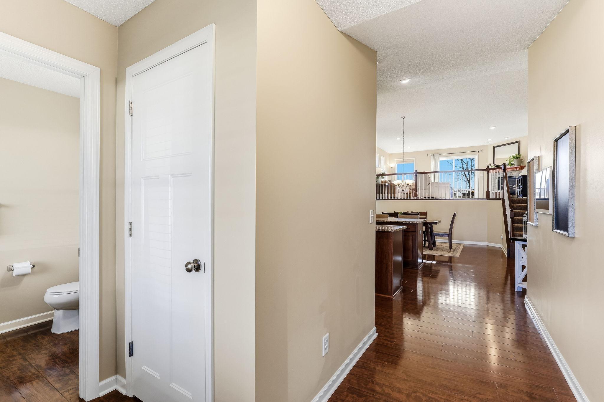 Gorgeous laminate wood flooring flows throughout the main level adding warmth, style, and a polished finish. The rich tones and quality craftsmanship create a cohesive look that enhances the overall design and feel.