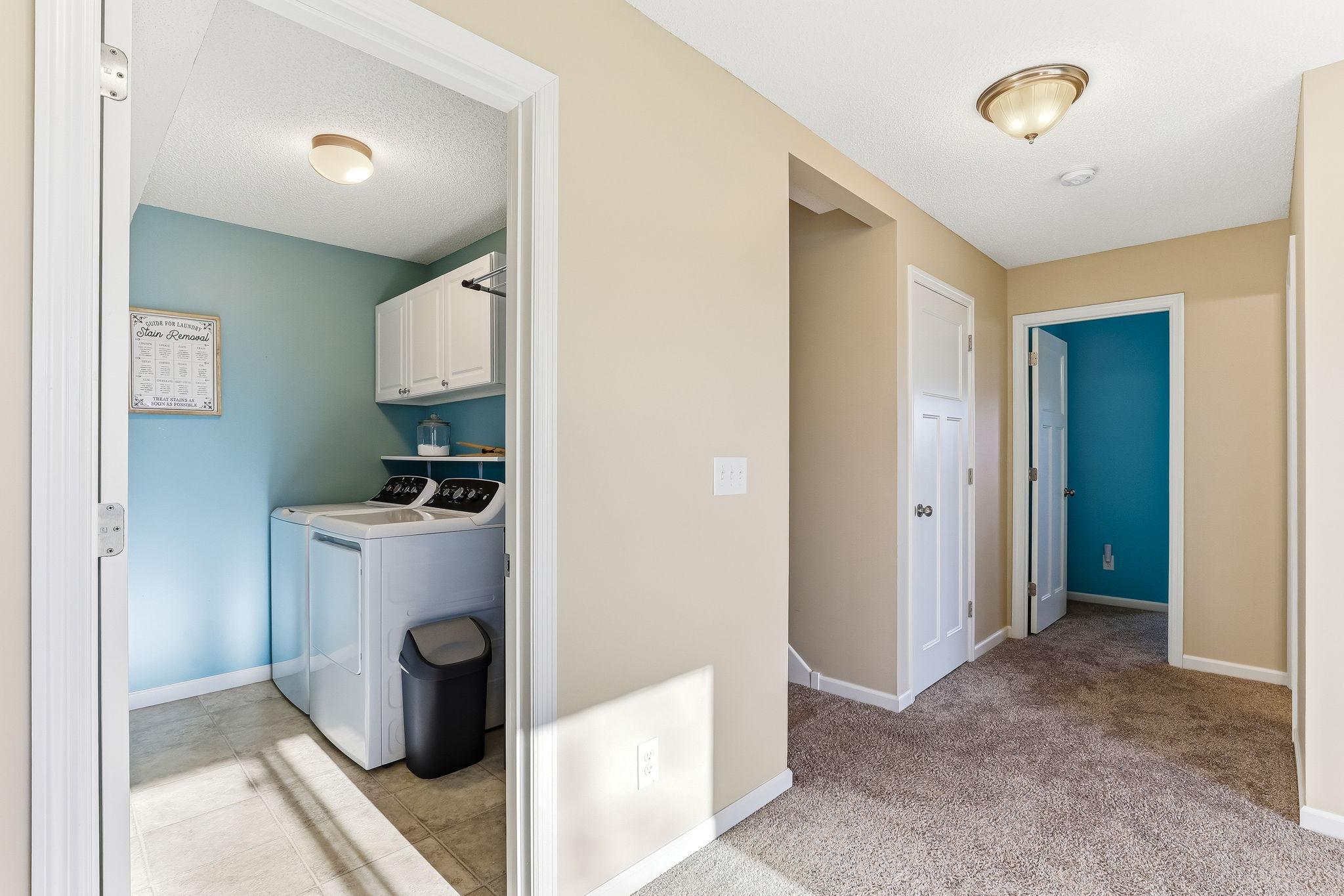 Dedicated lower-level laundry room offering a convenient and functional space for everyday chores.