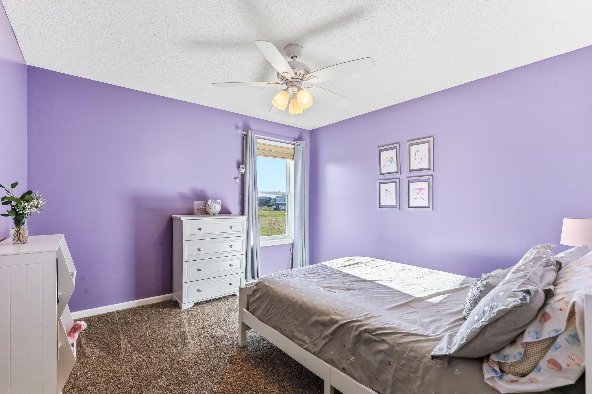 Third upper-level bedroom offering a comfortable and versatile space with a bright, welcoming feel.