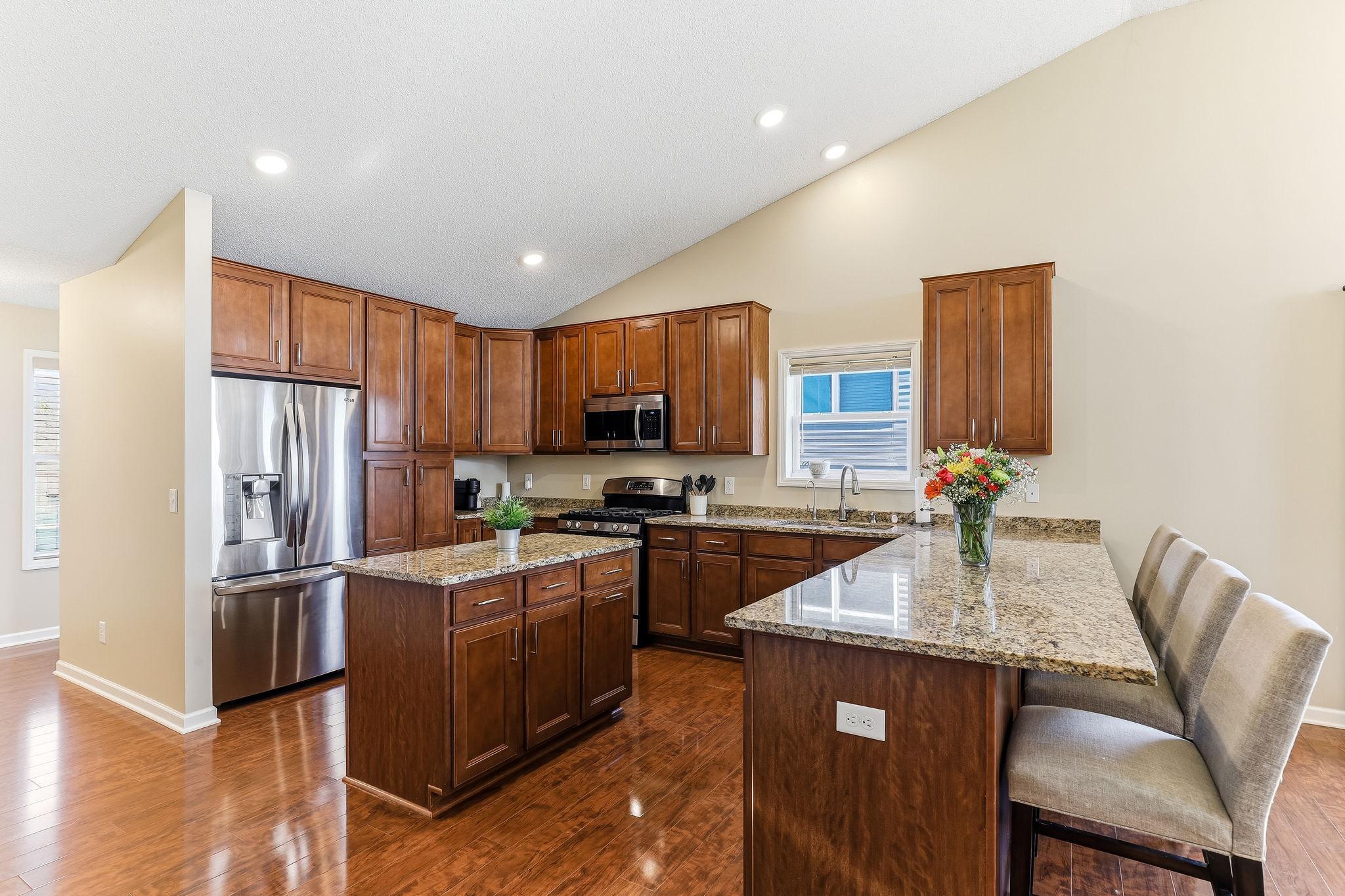 Complete with sleek stainless steel appliances, this space blends style and functionality for everyday living and entertaining.