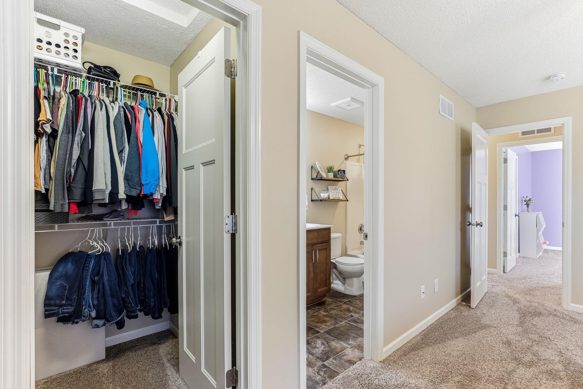 Primary suite featuring a spacious walk-in closet and adjoining primary bath offers a comfortable, private retreat.