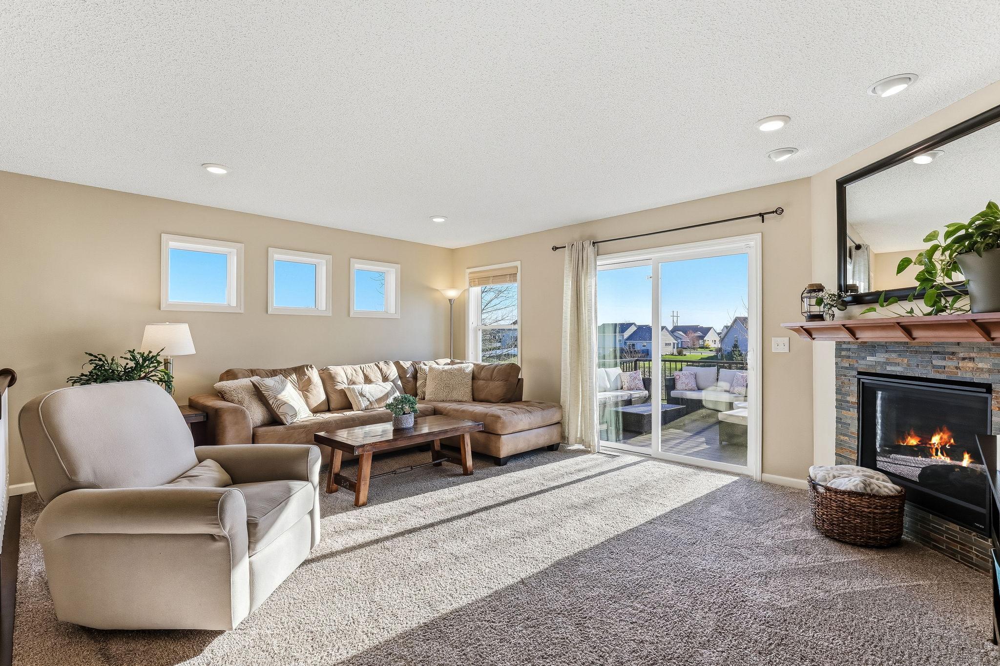Upper level living room featuring a cozy gas fireplace, creating a warm and inviting focal point.