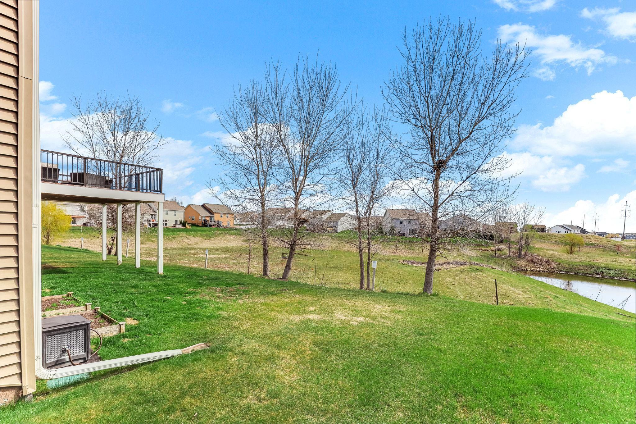 Serene backyard setting featuring a peaceful pond.
