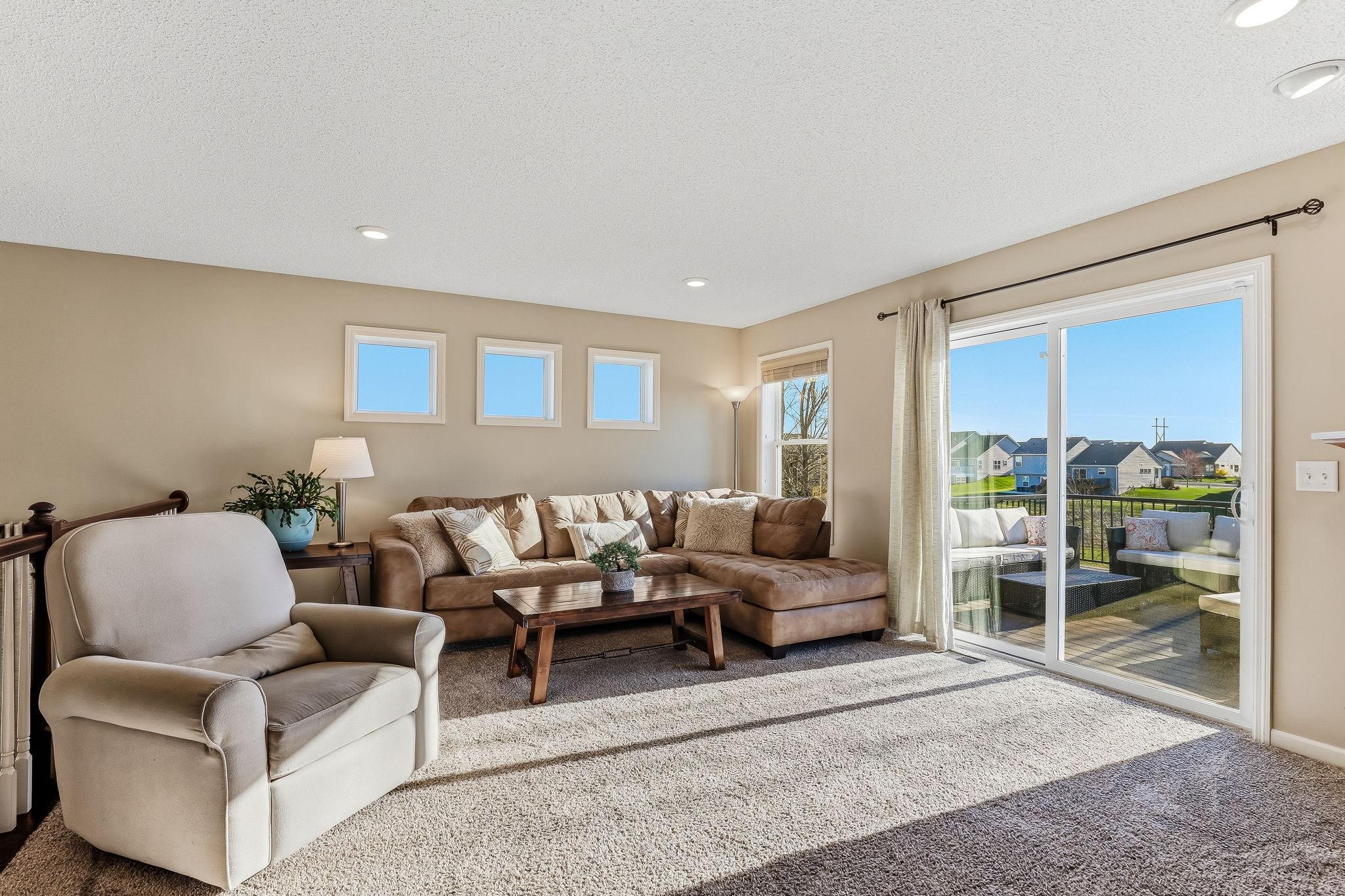 Sliding glass doors leading out to a brand new deck, offering easy indoor-outdoor living and a perfect space to relax or entertain.