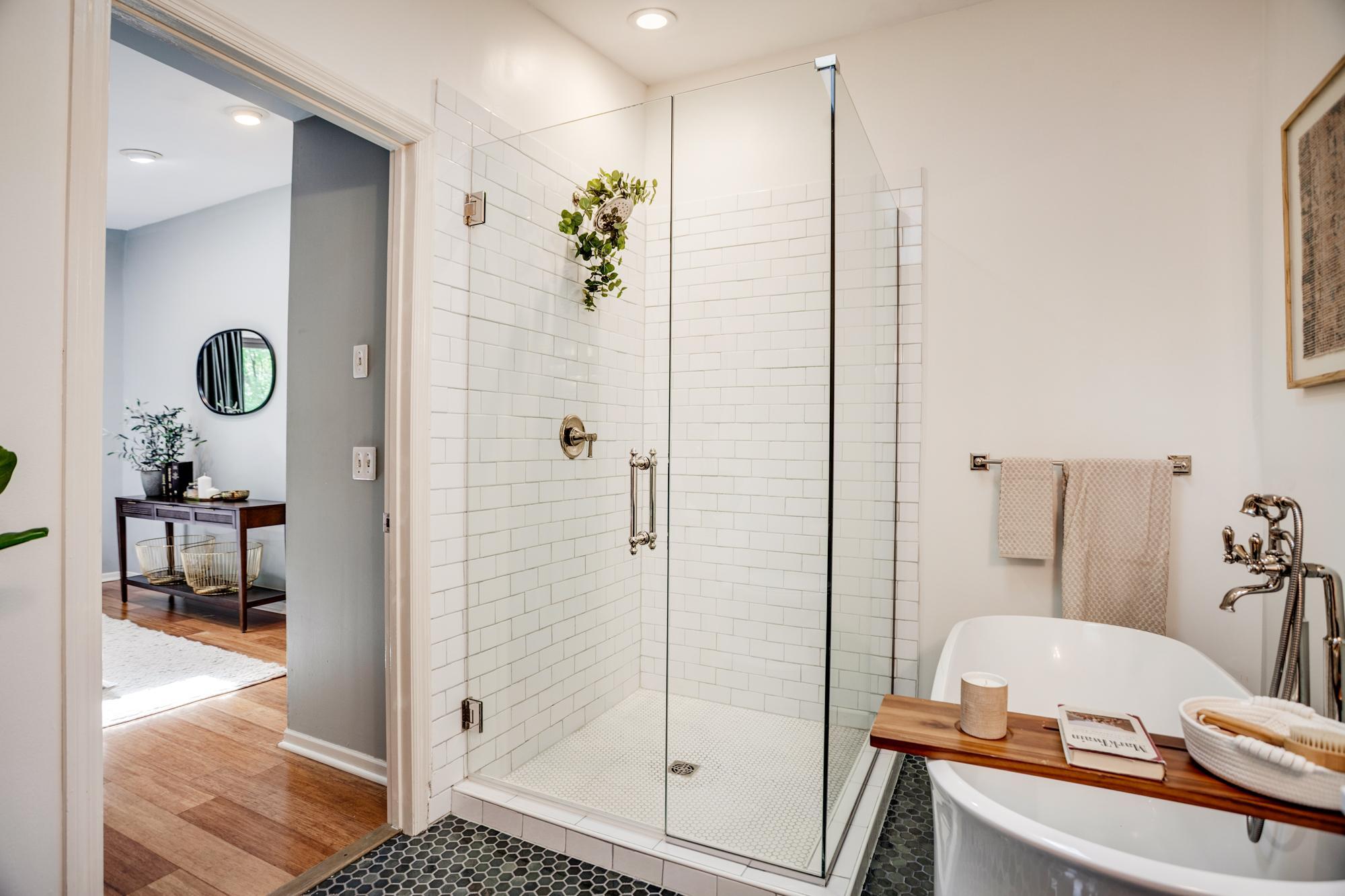 The ensuite bathroom was fully remodeled in 2024 with a walk-in shower, freestanding tub, polished nickel taps and fixtures, and hex tile flooring.