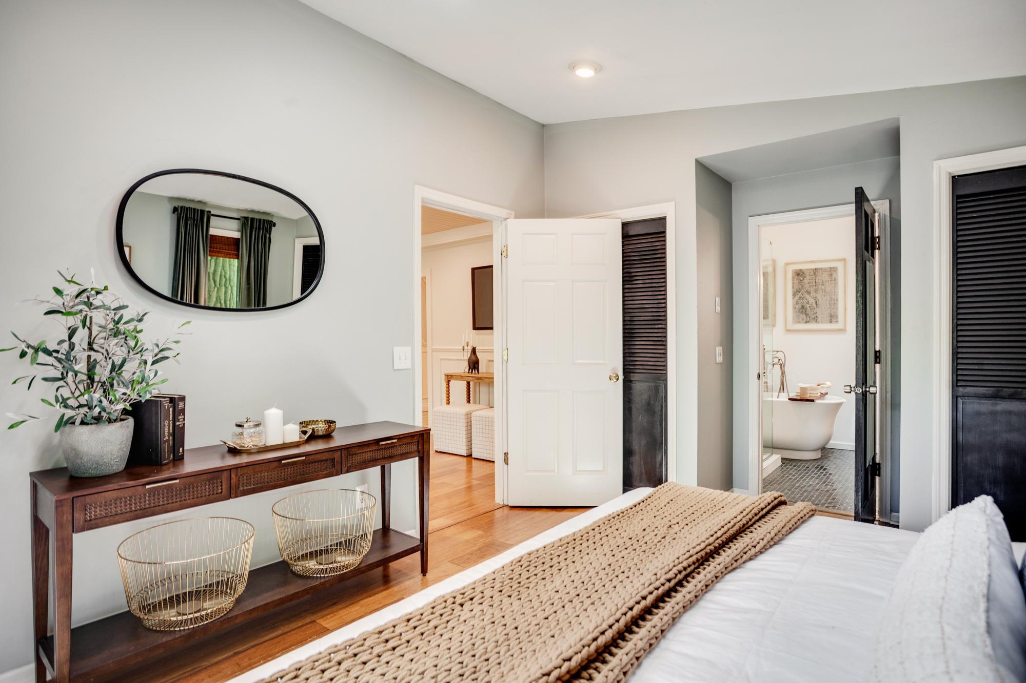 The main-level primary bedroom includes a remodeled ensuite bath and private access to the second deck.