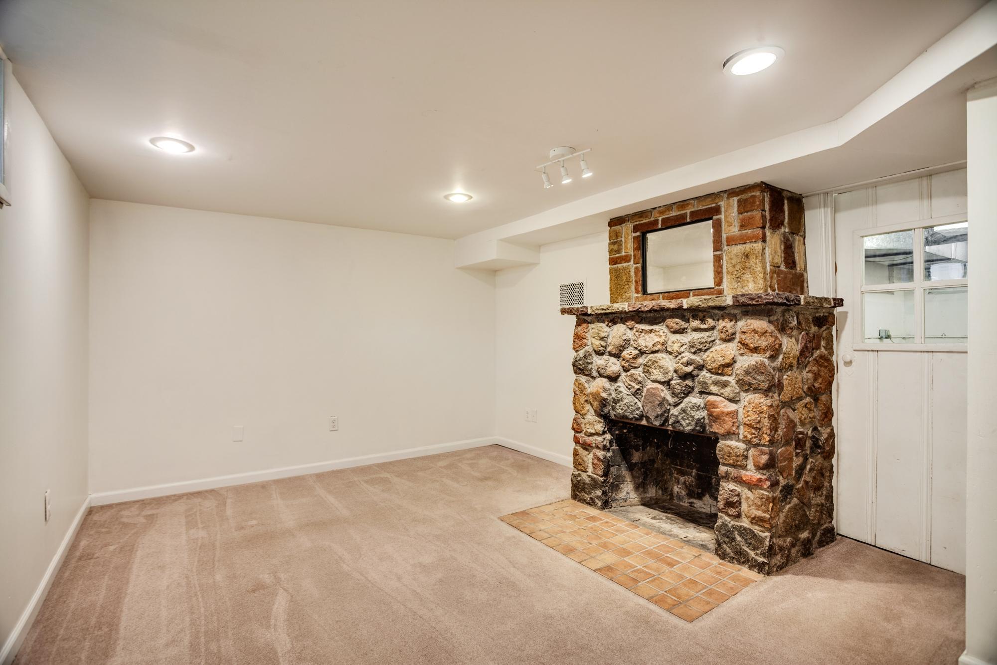 Lower level with family room, stone fireplace, laundry/utility room, workout room or flex room.
