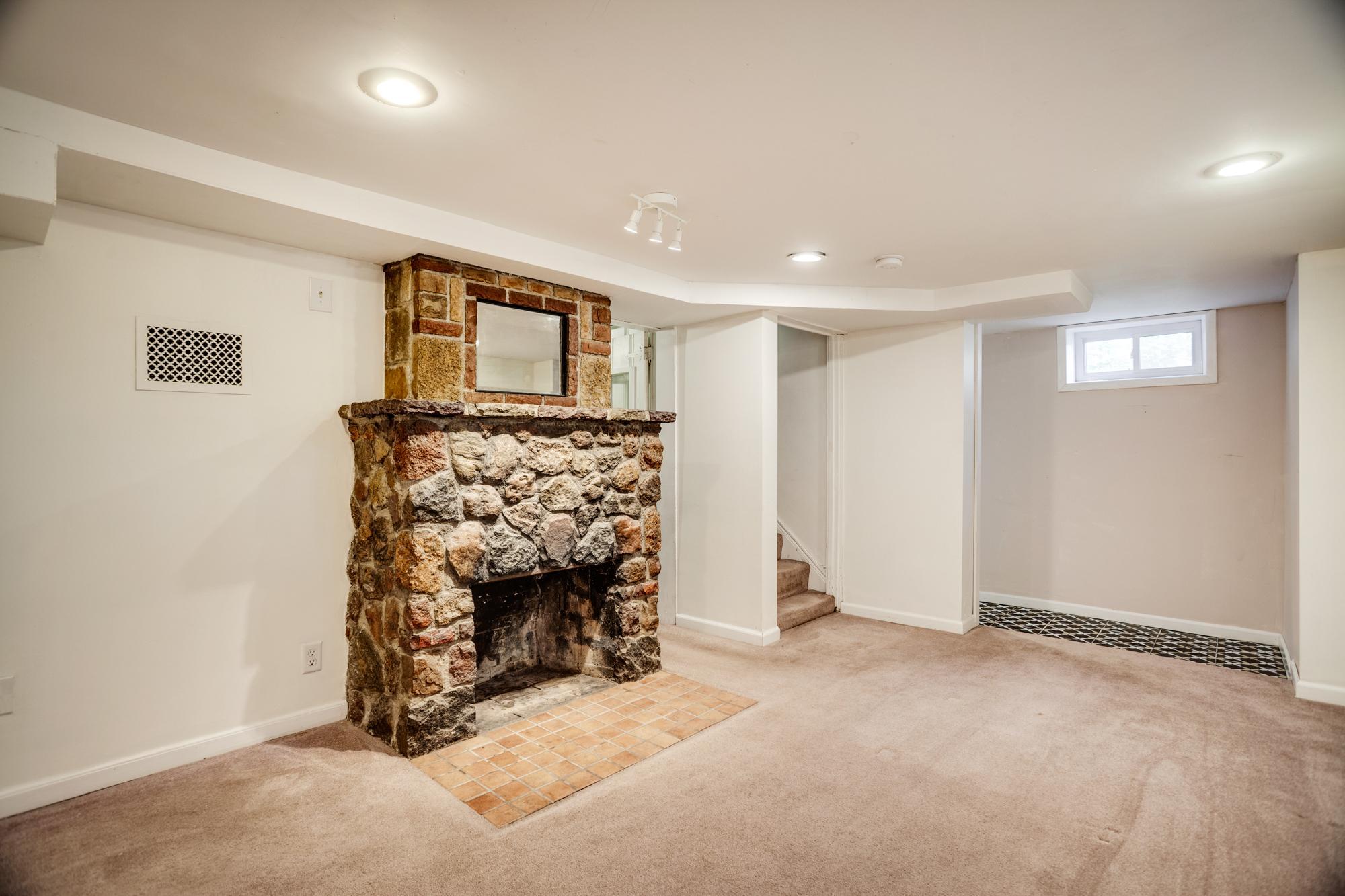 Lower level with family room, stone fireplace, laundry/utility room, workout room or flex room.