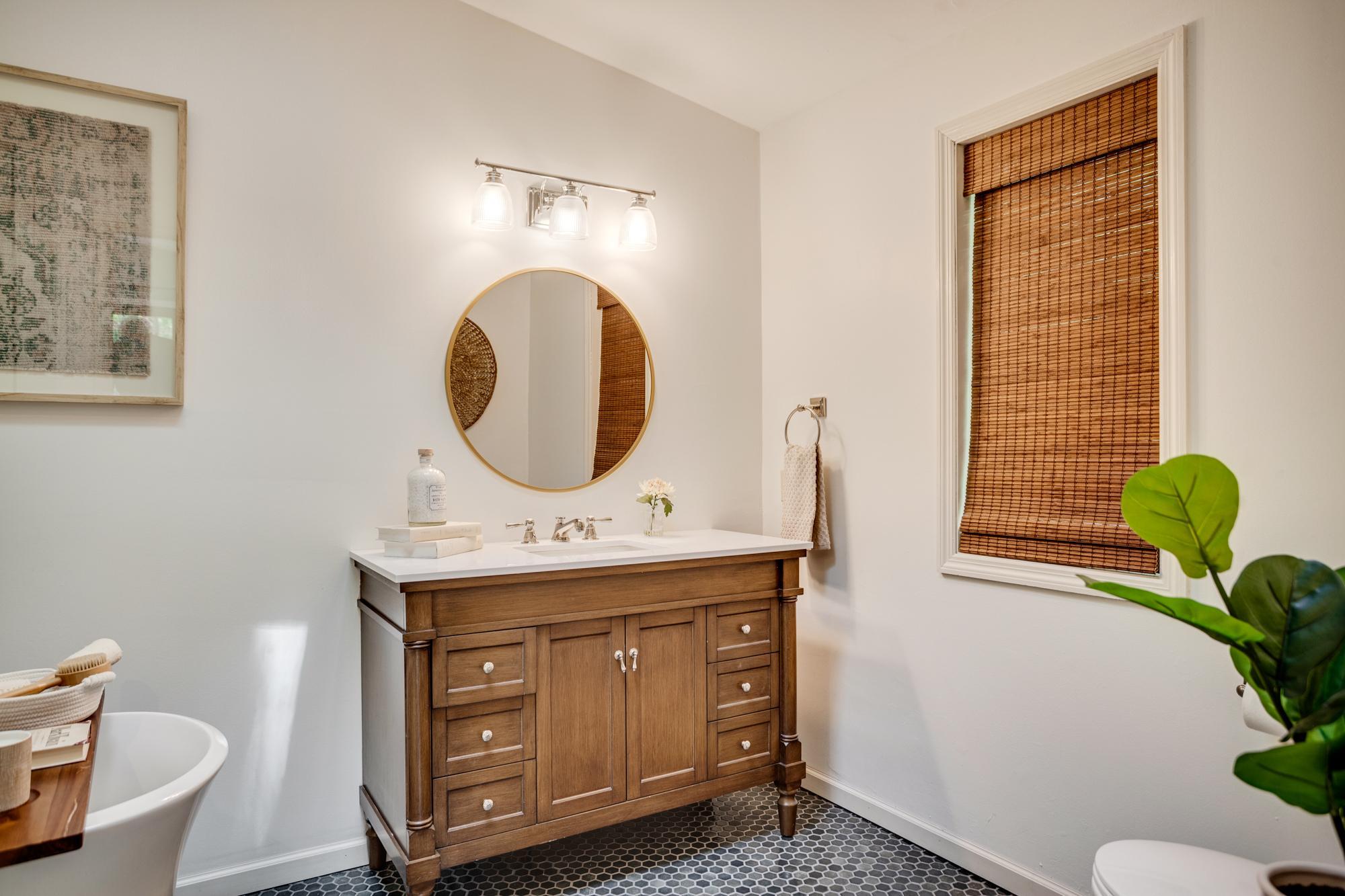 The ensuite bathroom was fully remodeled in 2024 with a walk-in shower, freestanding tub, polished nickel taps and fixtures, and hex tile flooring.