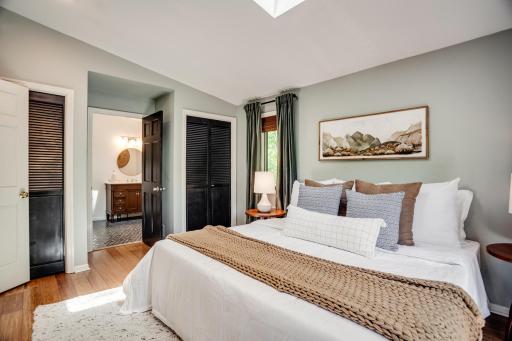 The main-level primary bedroom includes a remodeled ensuite bath and private access to the second deck.