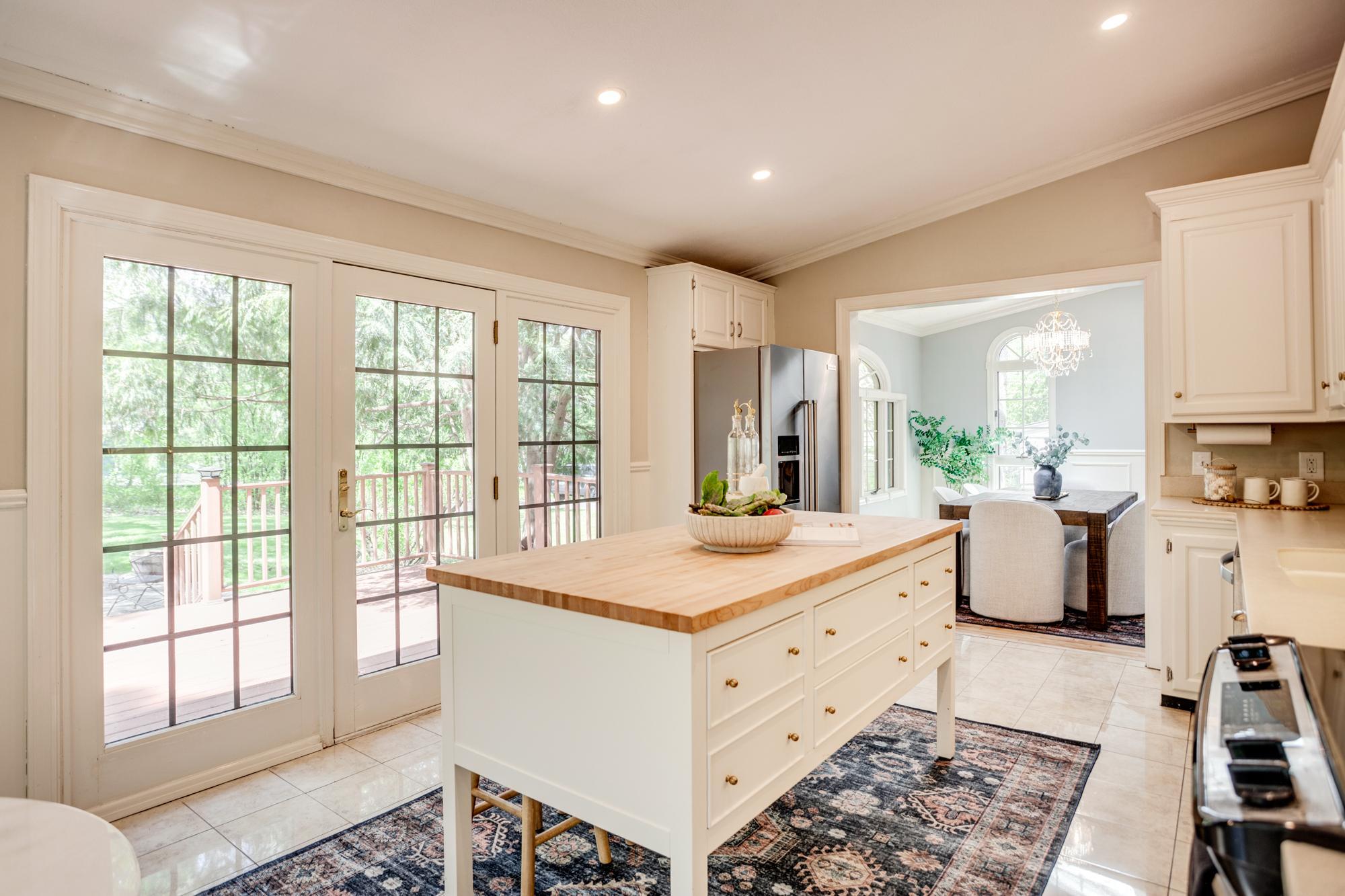 Patio doors open to the first of two decks, creating a natural connection between the indoor and outdoor spaces.
