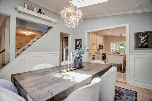 The formal dining room is flooded with natural light and leads into the kitchen.