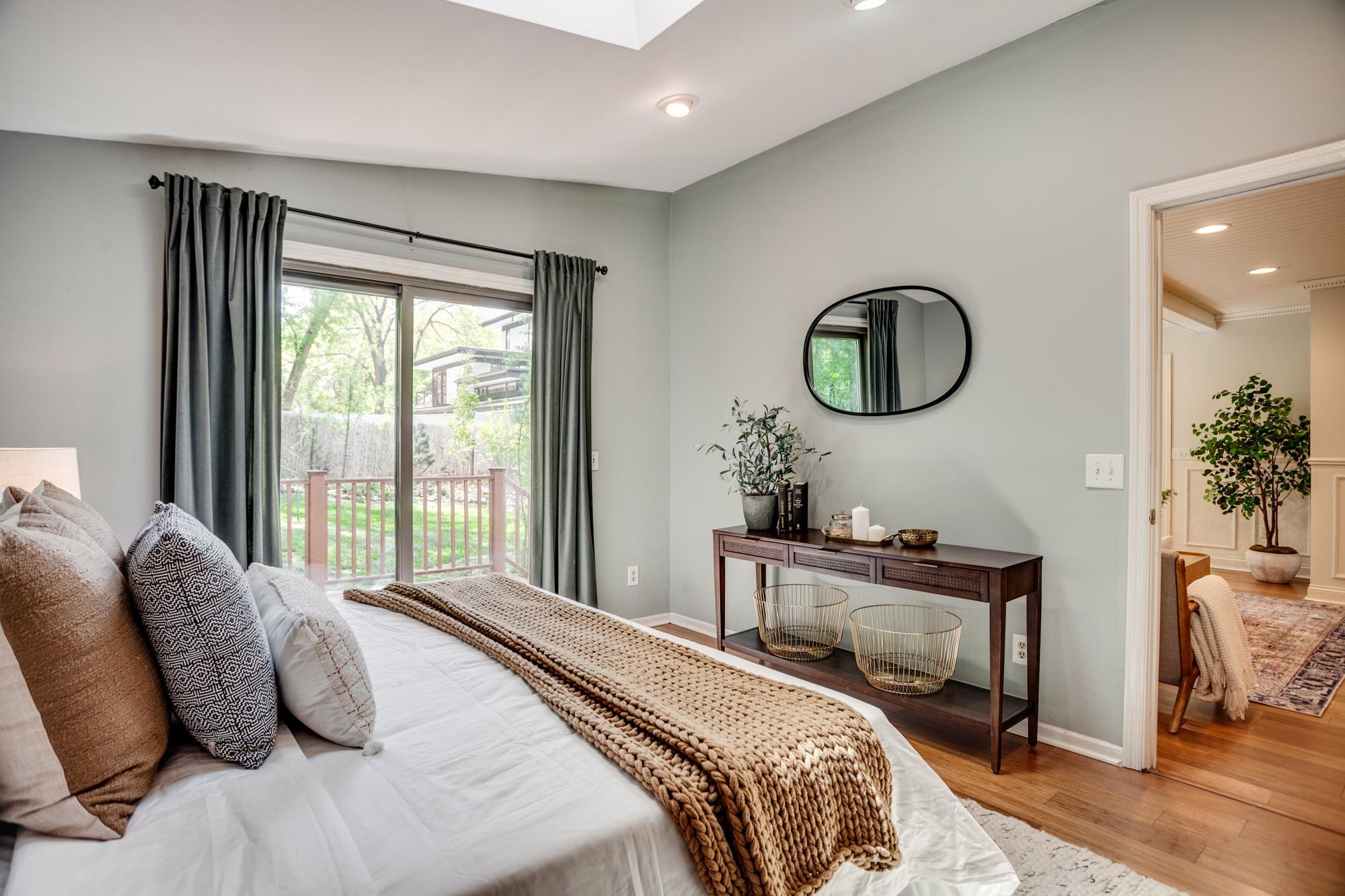 The main-level primary bedroom includes a remodeled ensuite bath and private access to the second deck.