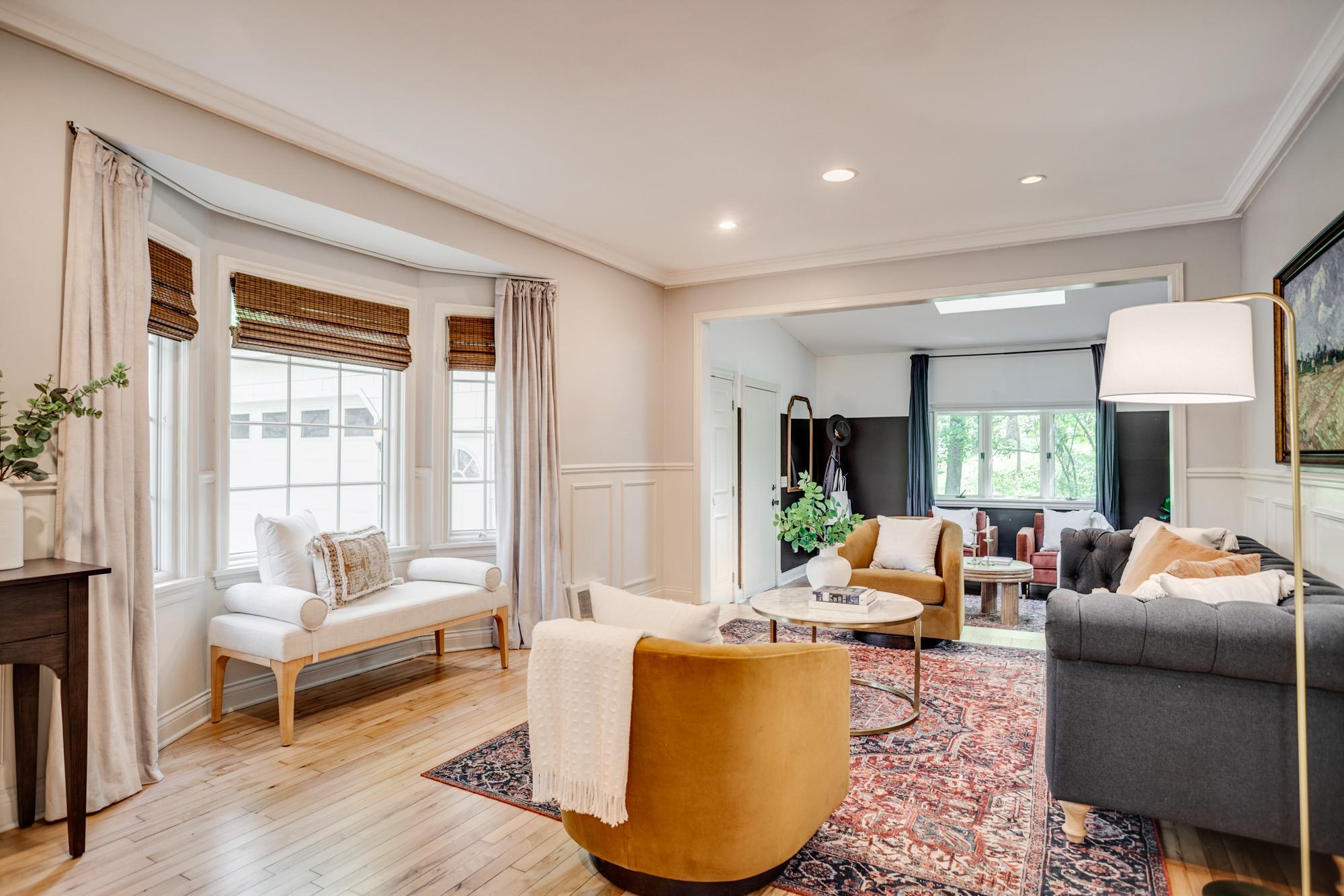 The living room features newly refinished hardwood floors and an adjoining den or sitting room.