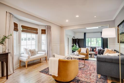 The living room features newly refinished hardwood floors and an adjoining den or sitting room.