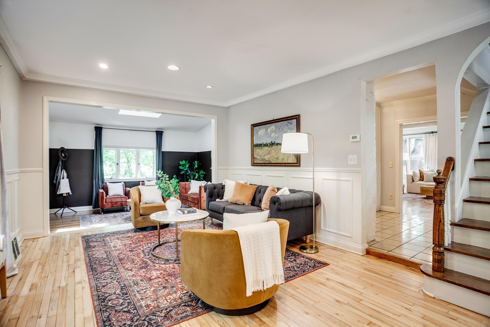 Inside, you're welcomed by an inviting living room with newly refinished hardwood floors and an adjoining den or sitting room.