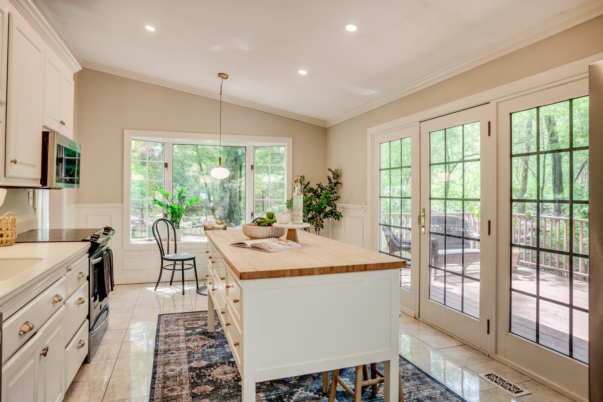 Patio doors open to the first of two decks, creating a natural connection between the indoor and outdoor spaces.