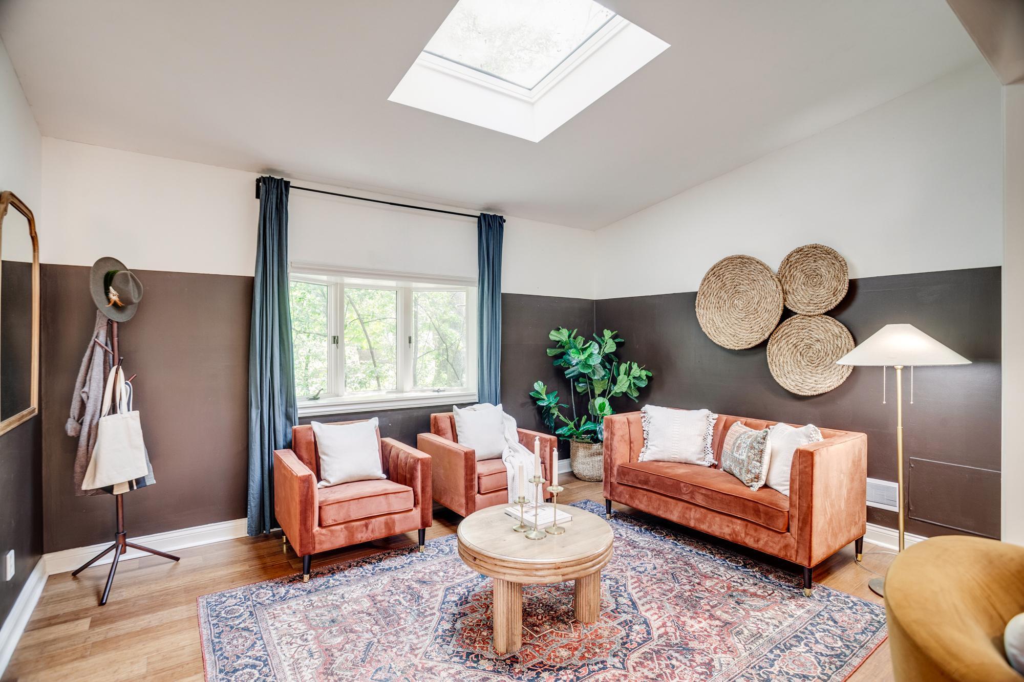 Main-level den or sitting room with newer skylights throughout the home.