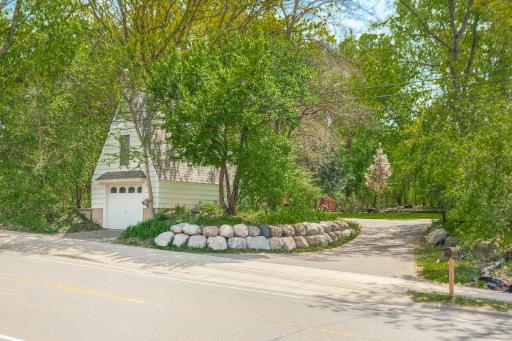 Detached third-car garage with boulder-lined entrance