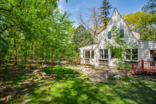 Outside, the peaceful surroundings include two decks, a brick patio, and multiple spaces to relax or entertain.