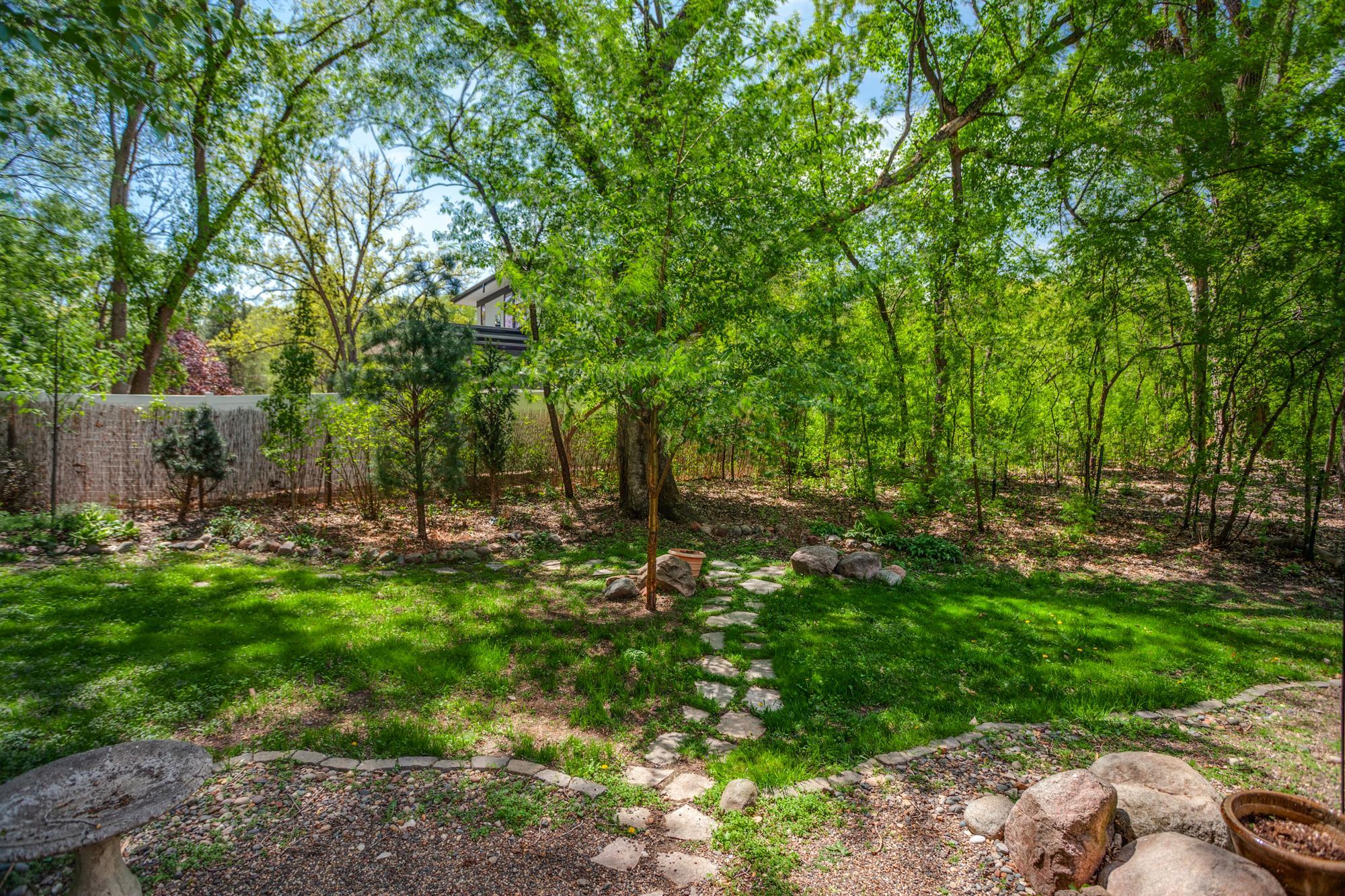 Outside, the peaceful surroundings include two decks, a brick patio, and multiple spaces to relax or entertain.
