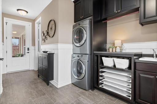 Large and convenient laundry and mudroom located off the 2-car garage. Side entrance also provides easy access into this "smart space" for dropping items and completing chores.