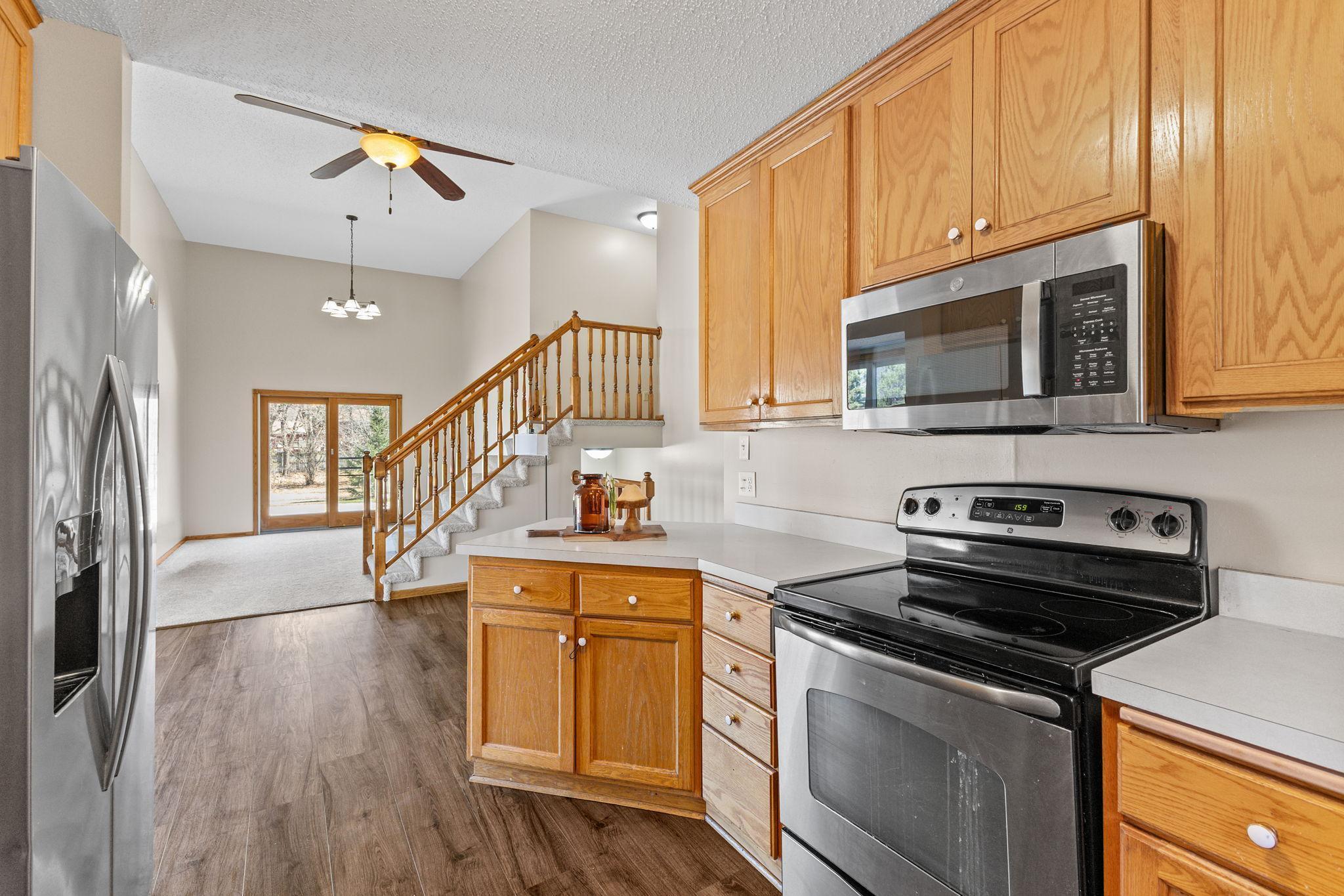 All new flooring flows seamlessly throughout the home, featuring hard surface floors in the kitchen and dining area that beautifully complement the cabinetry.